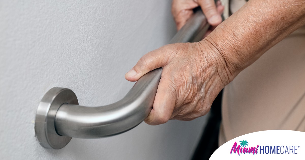 An older adult uses a grab bar representing one of the home modifications that is helpful for fall prevention for elderly adults.